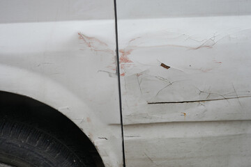A detailed closeup image showcasing the damaged fender and tire of a car