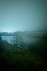 Fototapeta premium Night landscape photography at the winter , beautiful and horor place , wild and beautiful lake around the village cold and frost winter . Houses and cabin in the village at night 