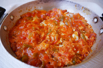 Turkish Menemen omelet in a frying pan. .