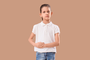 Teenage girl with appendicitis on beige background