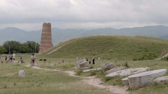 Tourists walk around the area of Burana Tower, a 10th century minaret or watch tower on the plains of Kyrgyzstan near Tok Mok.