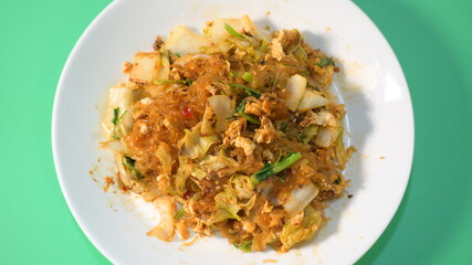 stir fried sukiyaki with egg and pork on white plate