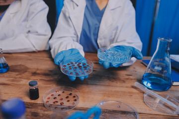 Blood test in the laboratory. Laboratory assistant working with the dispenser. Vacuum tubes with...