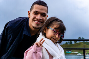 Happy family traveling. Niece with her uncle in a village in Colombia. People smiling. Children's day. 