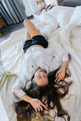 Asian woman resting on bed