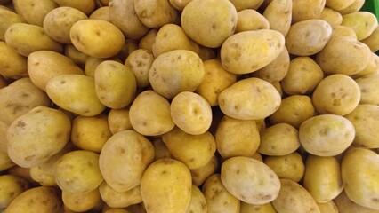Potatoes Displayed on Traditional Market Stall for Cooking Use