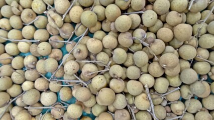 Longan Fruit Displayed Freshly on Traditional Market Stand