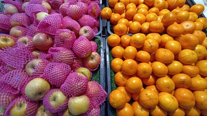 Fresh Apples and Oranges on Display at Traditional Market