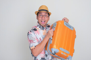 A tourist carry a luggage with surprised face expression