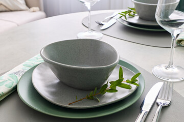 An Elegant Table Setting with Trendy Dishware, Beautiful Greenery, and Artful Touches