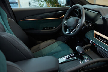 Closeup of a modern car steering wheel with control buttons for technology and convenience