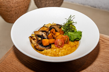 gourmet preparation of vegetarian risotto, made with mushrooms, cheese, cherry tomatoes, romaine lettuce and other vegetables.