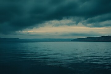 Fototapeta premium Moody seascape under dark clouds at sunset.
