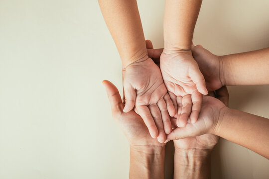 Celebrating Family Day, Top view of parents and kid holding empty hands isolated. Representing togetherness support and generational legacy.