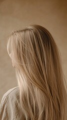 Naklejka premium Back view of a woman with long blonde hair.
