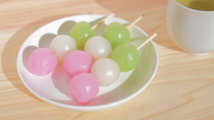 Spring image of three-colored Japanese mochi sweets with green tea