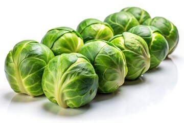 Obraz premium Crisp Brussels sprouts gleam against a white backdrop, depth of field highlighting their freshness.
