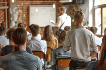 Fototapeta premium Young People Engaged in a Collaborative Meeting in a Modern Office Room with Brick Walls and a Whiteboard Presentation