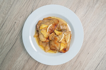 Baked chicken thighs with pineapple on wood table, Top view