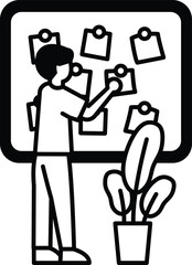 A man is putting up notes on a board