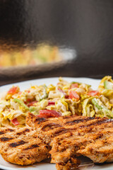 Delicious Grilled turkey Served with a salad on a Rustic Wooden Dining Table