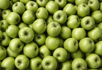 A close-up of a pile of green apples