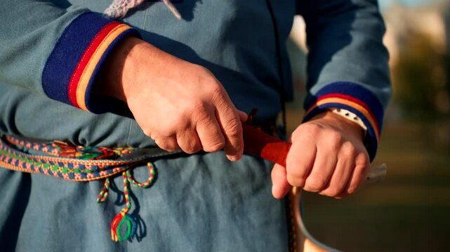 Closeup Of Sami Person In Traditional Clothing Putting Back The Knife On Its Wooden Case.