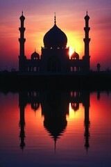 Naklejka premium Beautiful sunset is reflected in the water next to a large, ornate building. The water is calm and still, creating a serene and peaceful atmosphere. The building is a mosque