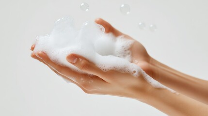 Fototapeta premium Soapy hands holding a bubble mixture.