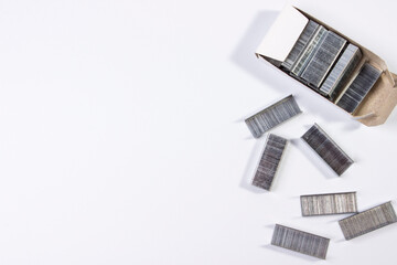 staples for a stationery stapler on a white background and a place for text