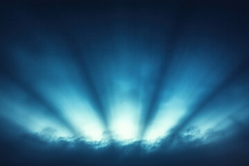 Obraz premium Light rays shining through dark clouds.