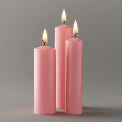 Three pink candles isolated on a grey background