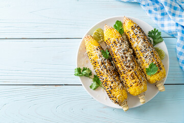 barbecue and grilled corn with cheese and lime
