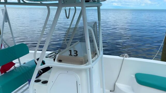 Panning view, fishing boat tied to dock during daytime, Florida Keys, Marathon