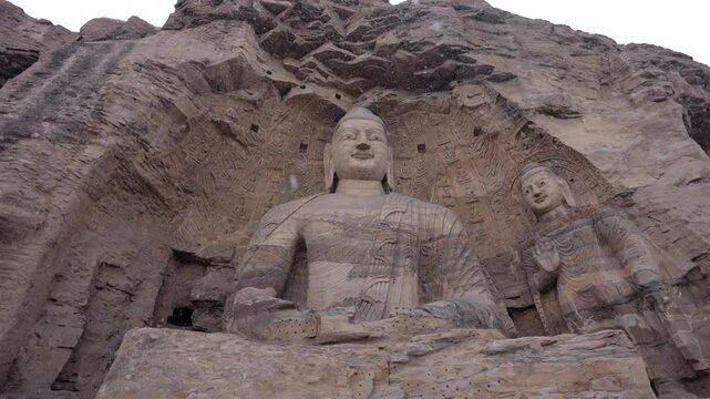 The Yungang Grottoes in Datong, Shanxi, China, were originally built 1500 years ago during the Northern Wei Dynasty. They are huge and exquisite stone carvings of Buddha statues in ancient China
