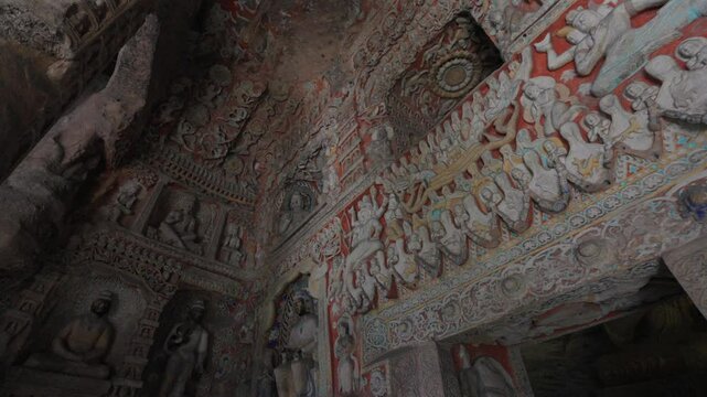 The Yungang Grottoes in Datong, Shanxi Province, China, were originally built 1500 years ago during the Northern Wei Dynasty, featuring huge and exquisite Buddha sculptures
