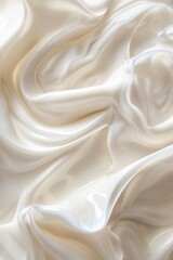 Closeup of foamy cream with drops and swirls. Dairy products, dessert toppings or whipped cream. Highly detailed texture.