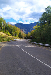 paved highway in a mountainous area in early autumn with panoramic views
