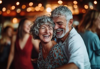 An elderly couple dancing joyfully at an indoor dance party, surrounded by other couples enjoying the music and laughter