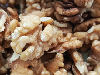 A bunch of walnuts in close-up. Júglans régia. Fruits of a tree of the Juglandaceae family.