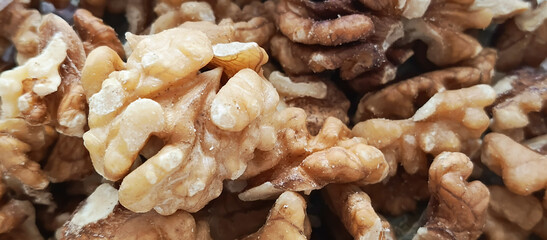 A bunch of walnuts in close-up. Júglans régia. Fruits of a tree of the Juglandaceae family.