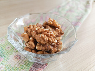 Walnuts in a transparent cup. Minerals and vitamins in nuts. Soaking nuts in water before eating. 