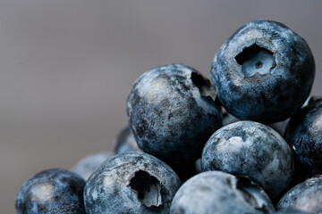 Close-up of blueberries on dark background.Fresh Blueberry Bounty. Close-up of ripe juicy blueberries filling the frame
