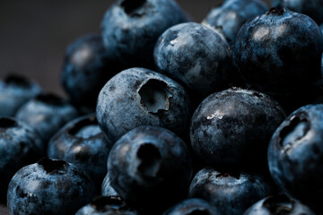 Close-up of blueberries on dark background.Fresh Blueberry Bounty. Close-up of ripe juicy blueberries filling the frame