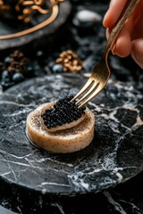 Fototapeta premium Hand holding a fork with edible diamonds on top of an oyster with a pearl inside it. The dish is elegant and exclusive, resembling luxury cuisine.