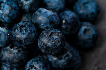 Close-up of blueberries on dark background.Fresh Blueberry Bounty. Close-up of ripe juicy blueberries filling the frame