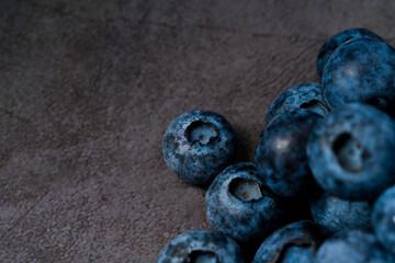 Close-up of blueberries on dark background.Fresh Blueberry Bounty. Close-up of ripe juicy blueberries filling the frame