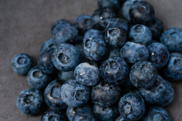 Close-up of blueberries on dark background.Fresh Blueberry Bounty. Close-up of ripe juicy blueberries filling the frame