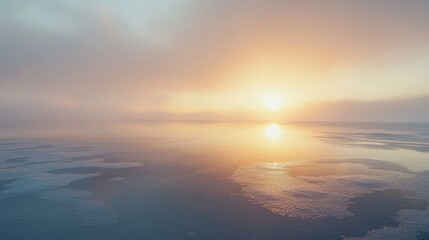 Fototapeta premium Serene Sunrise Over Calm Ocean with Misty Horizon and Soft Reflections