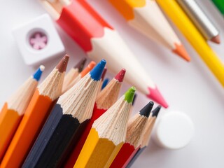Bright orange pencil standing out in a pile of sharp pencil shavings, colorful, school project